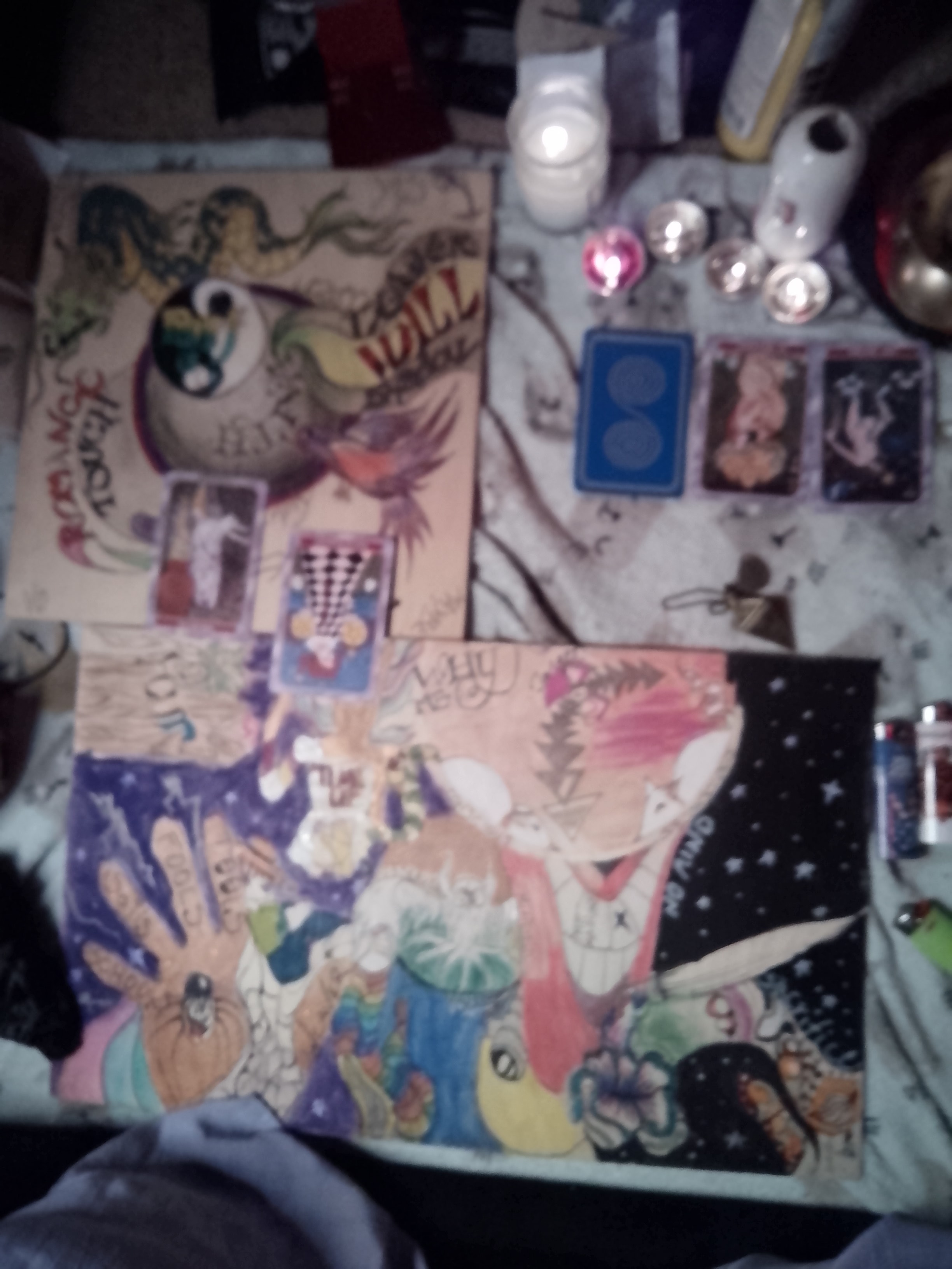 Tarot cards and pendulum laid out on a reading surface